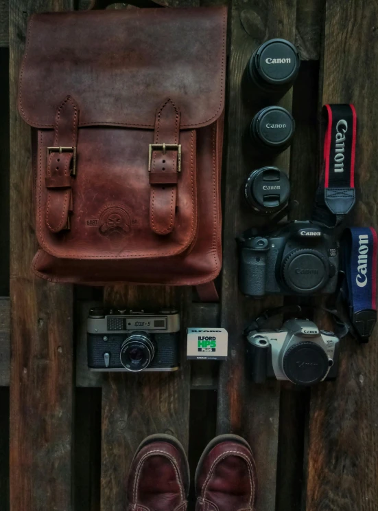 a pair of brown shoes sitting on top of a wooden floor, inspired by Steve McCurry, unsplash contest winner, small vials and pouches on belt, dutch camera view, backpack, high quality product image”