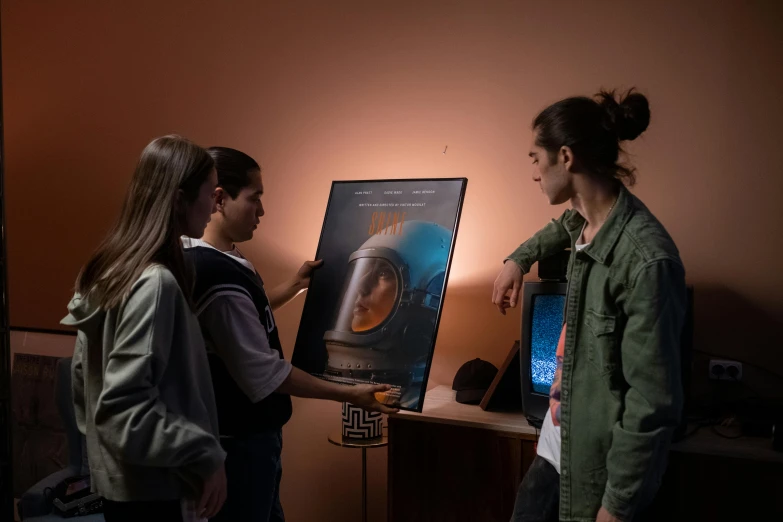 a couple of people standing in front of a painting, a poster, trending on unsplash, interactive art, wearing a space helmet, 3 sisters look into the mirror, with cinematic lighting, product introduction photo