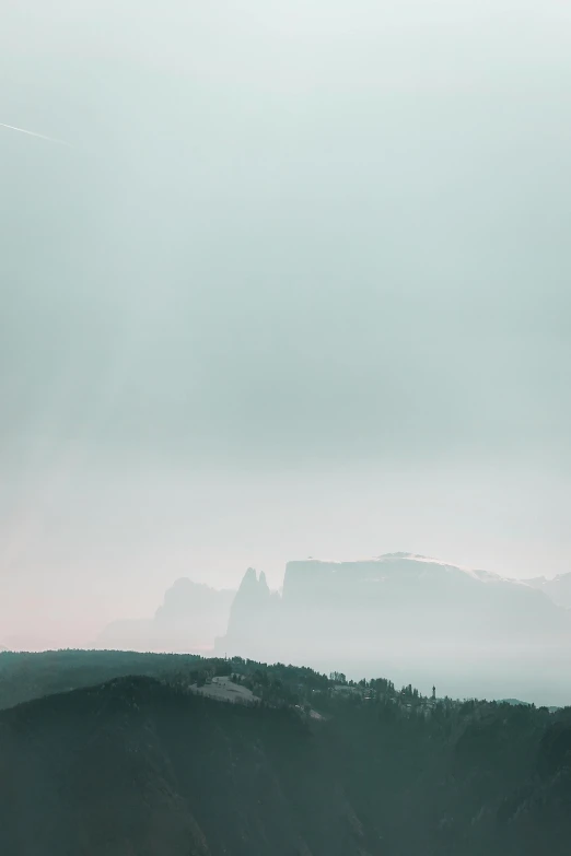 a man flying a kite on top of a lush green hillside, a matte painting, unsplash contest winner, romanticism, observed from afar in the fog, sedona's cathedral rock bluff, 4k), iceland photography