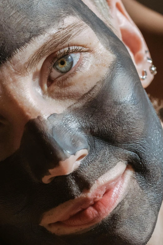 a close up of a person with a face mask, inspired by Hedi Xandt, reddit, charcoal color skin, digging, high quality photo, square masculine facial features