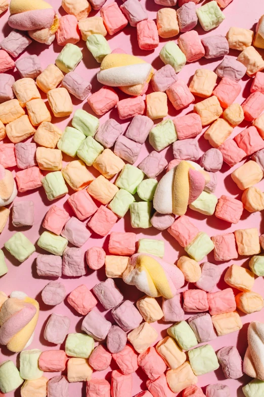 a pile of marshmallows sitting on top of a pink surface, gummy candies, photograph from above, detailed product image, detail shot
