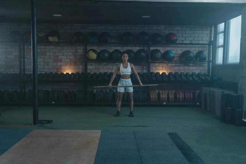 a woman holding a bar in a gym, pexels contest winner, vfx render, centered full body, low quality footage, with axe