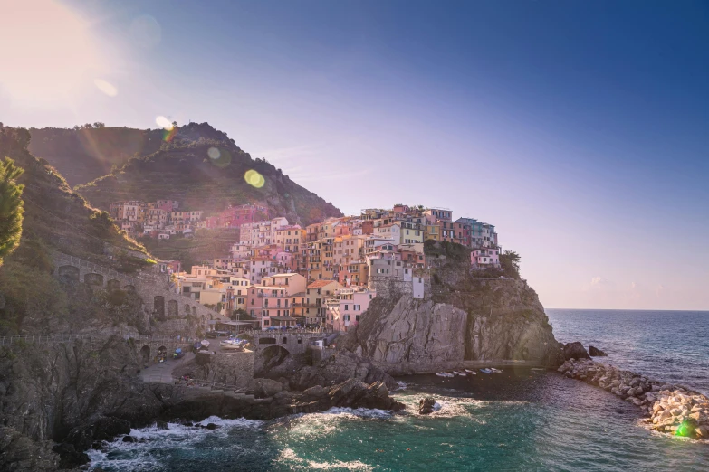 a large body of water next to a cliff, by Patrick Pietropoli, pexels contest winner, renaissance, sunlight and whimsical houses, pastel hues, bulgari, hills and ocean