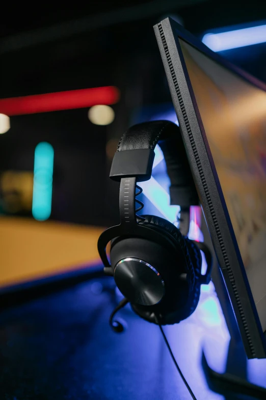 a computer monitor sitting on top of a desk, wearing gaming headset, light lighting side view, profile picture 1024px, detail shot