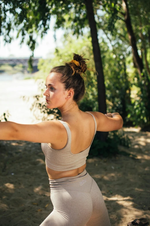 a woman throwing a frisbee in a park, pexels contest winner, renaissance, detailed sports bra, back arched, portrait sophie mudd, yoga