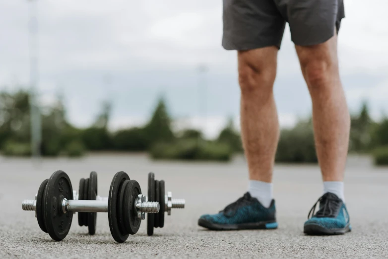 a man standing next to a pair of dumb dumb dumb dumb dumb dumb dumb dumb dumb dumb dumb dumb dumb dumb dumb dumb dumb dumb dumb dumb, by Adam Marczyński, pexels contest winner, realism, working out, knobbly knees, colour corrected, outdoor photo