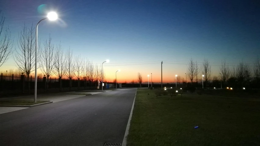 a street light sitting on the side of a road, a picture, reddit, sunset + hdri, moonlight lighting, clear sky, a park