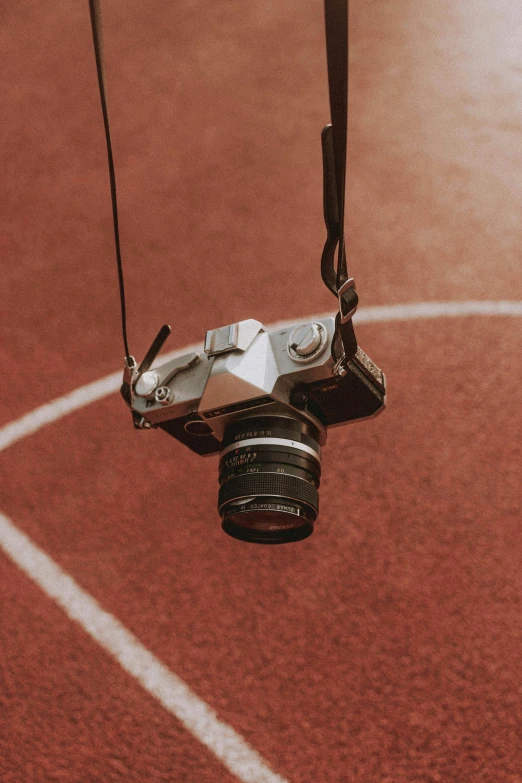 a close up of a camera on a string, pexels contest winner, athlete photography, top down photo, ground camera, shot on red camera