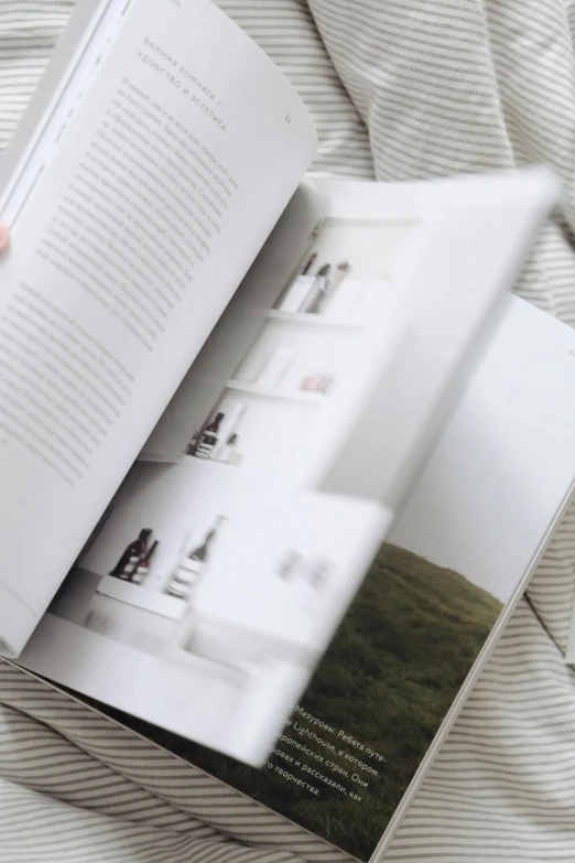 a person reading a book on a bed, unsplash contest winner, private press, architectural magazine, on white paper, bath, product display photograph