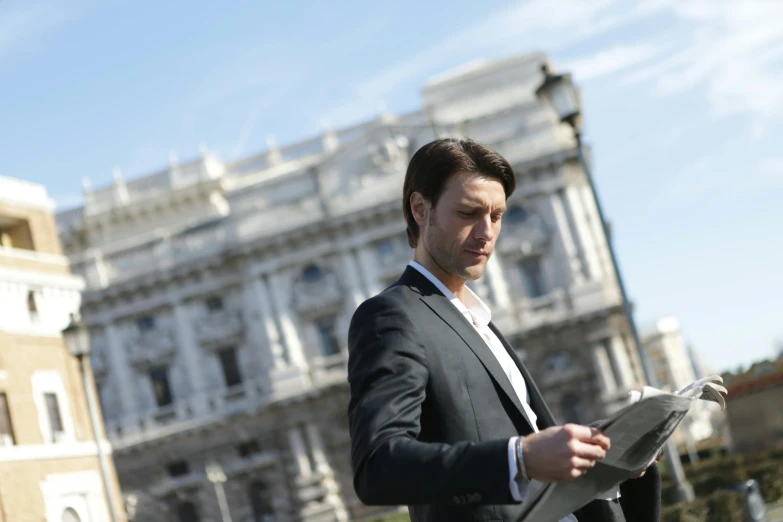 a man in a suit reading a newspaper, by Giuseppe Avanzi, pexels contest winner, renaissance, white marble buildings, avatar image, tobey maguire, 278122496