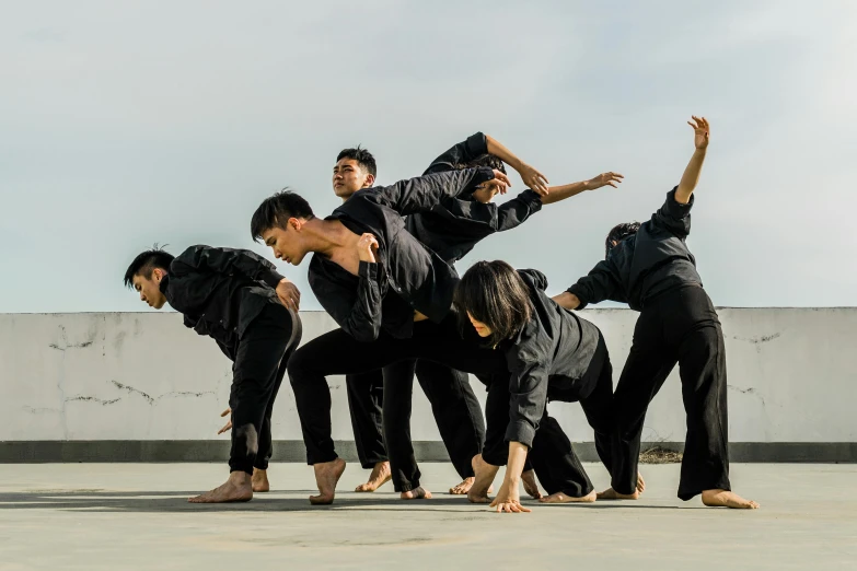 a group of men standing on top of each other, unsplash, conceptual art, contemporary dance, asia, profile image, schools