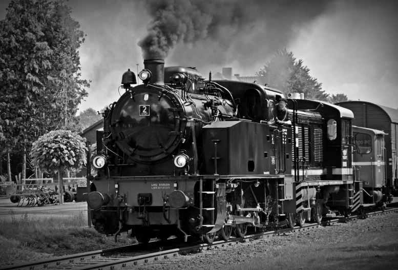 a black and white photo of a train on the tracks, a black and white photo, by Kristian Zahrtmann, pixabay contest winner, art nouveau, gunpowder smoke, 1 9 4 0 picture, front, big engine