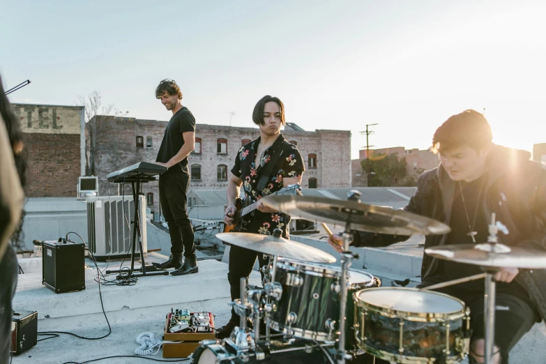 a group of people standing on top of a roof, a portrait, by Winona Nelson, unsplash, bauhaus, band playing, soft cracks, tyler west, official store photo