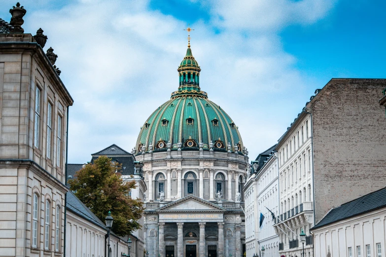 a group of people walking down a street in front of a building, a photo, by Adriaen Hanneman, pexels contest winner, neoclassicism, dome, verdigris, panorama, square