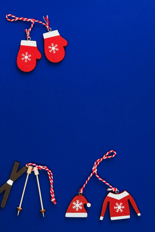 a pair of skis and a pair of mittens on a blue background, by Julia Pishtar, pexels contest winner, ornaments, thumbnail, mini model, streamers