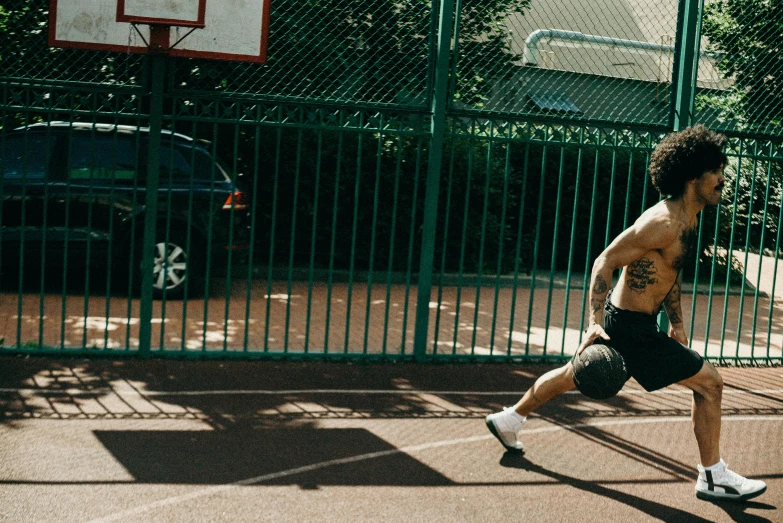 a man standing on top of a tennis court holding a racquet, pexels contest winner, playing basketball, running sequence, tight black tank top and shorts, parkour