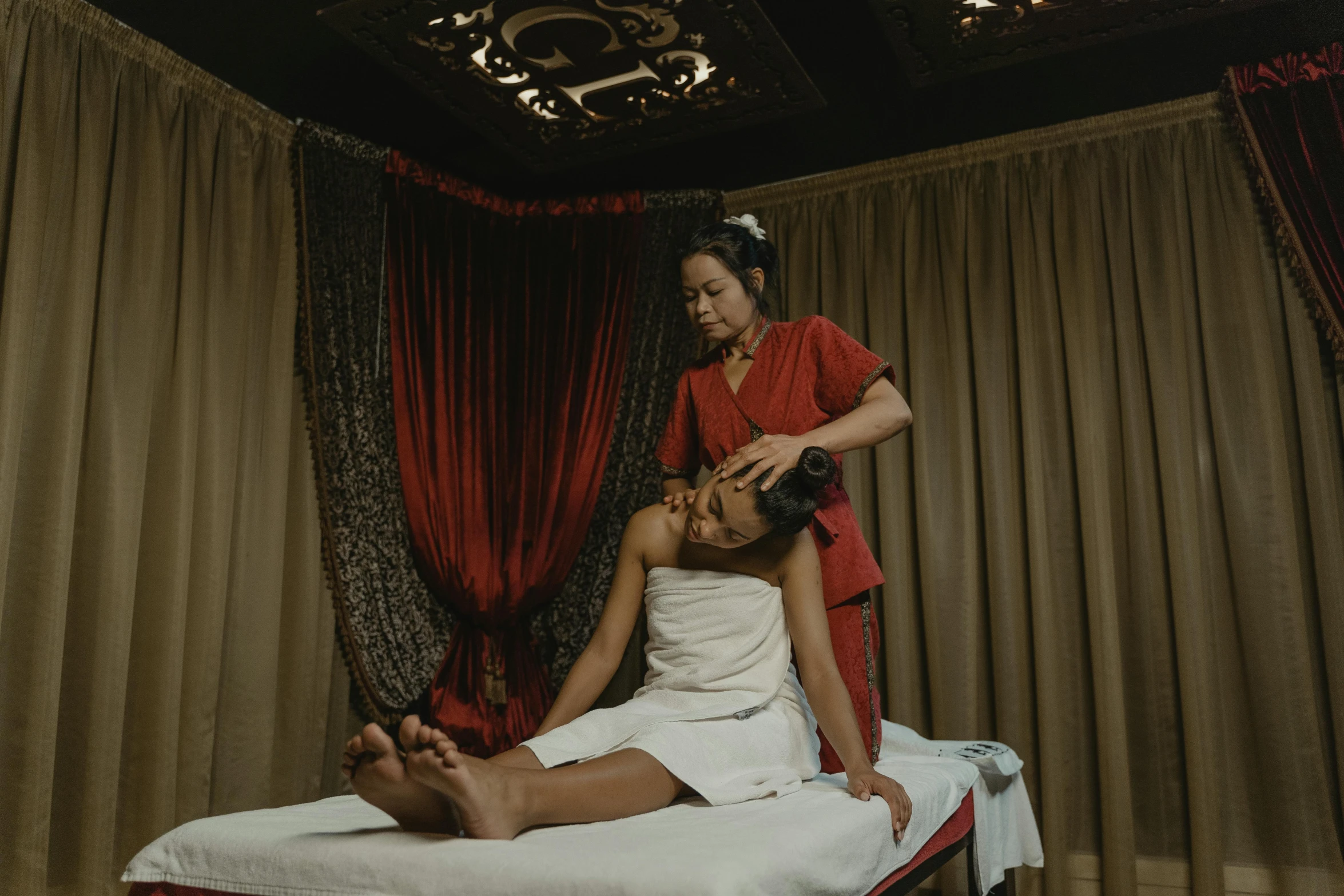 a woman getting a massage at a spa, a portrait, unsplash, renaissance, layed on a red velvet fabric, asian descent, thumbnail, 2000s photo