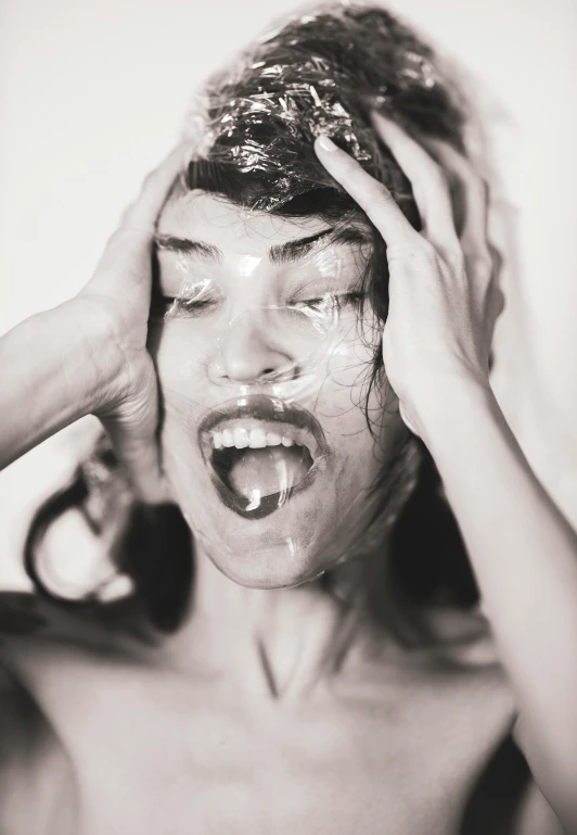 a black and white photo of a woman brushing her hair, a black and white photo, trending on pexels, surrealism, cracked plastic wrap, screaming fashion model face, mila jovovich as spiderwoman, person made out of glass