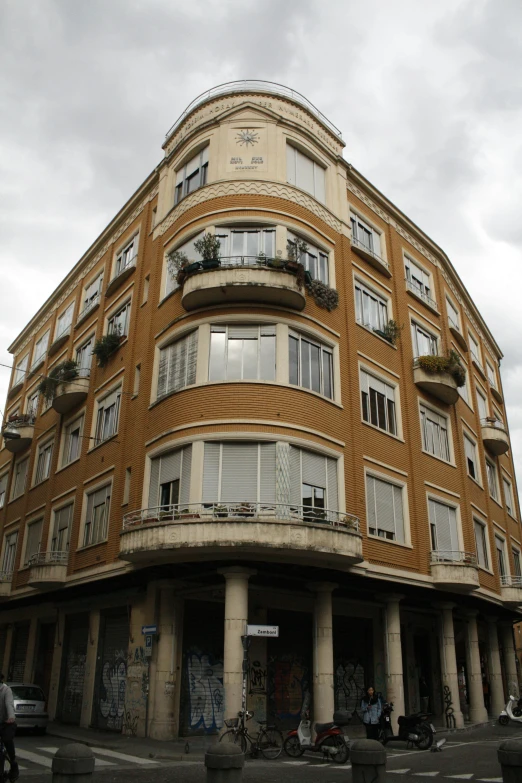 a tall building sitting on the corner of a street, by Hirosada II, crenellated balconies, pareidolia, very very precise, that resembles a bull\'s