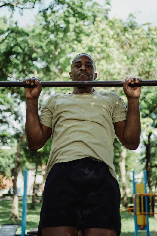 a man is doing pull ups in the park, a portrait, pexels contest winner, 15081959 21121991 01012000 4k, square, plain background, jemal shabazz