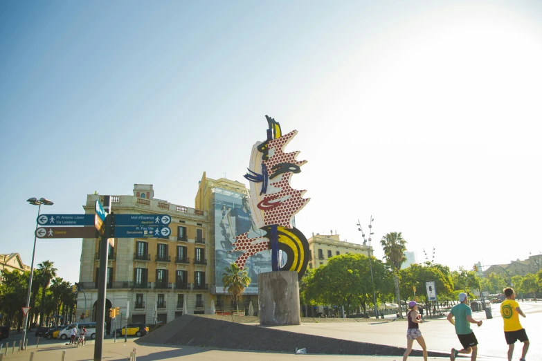 a group of people walking down a street next to a tall building, an abstract sculpture, by Carlo Carrà, street art, near the beach, roy lichtenstein style, sculpture made of gold, 🚿🗝📝