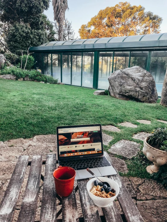 a laptop computer sitting on top of a wooden table, by Emma Andijewska, happening, greenhouse in the background, small wellness relaxation pool, 👰 🏇 ❌ 🍃, italian masterpiece