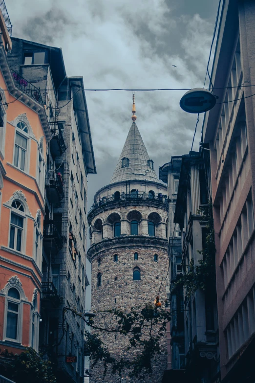 a tall clock tower towering over a city street, a colorized photo, inspired by Altoon Sultan, pexels contest winner, turrets, the fall of constantinople, gray, multilayer