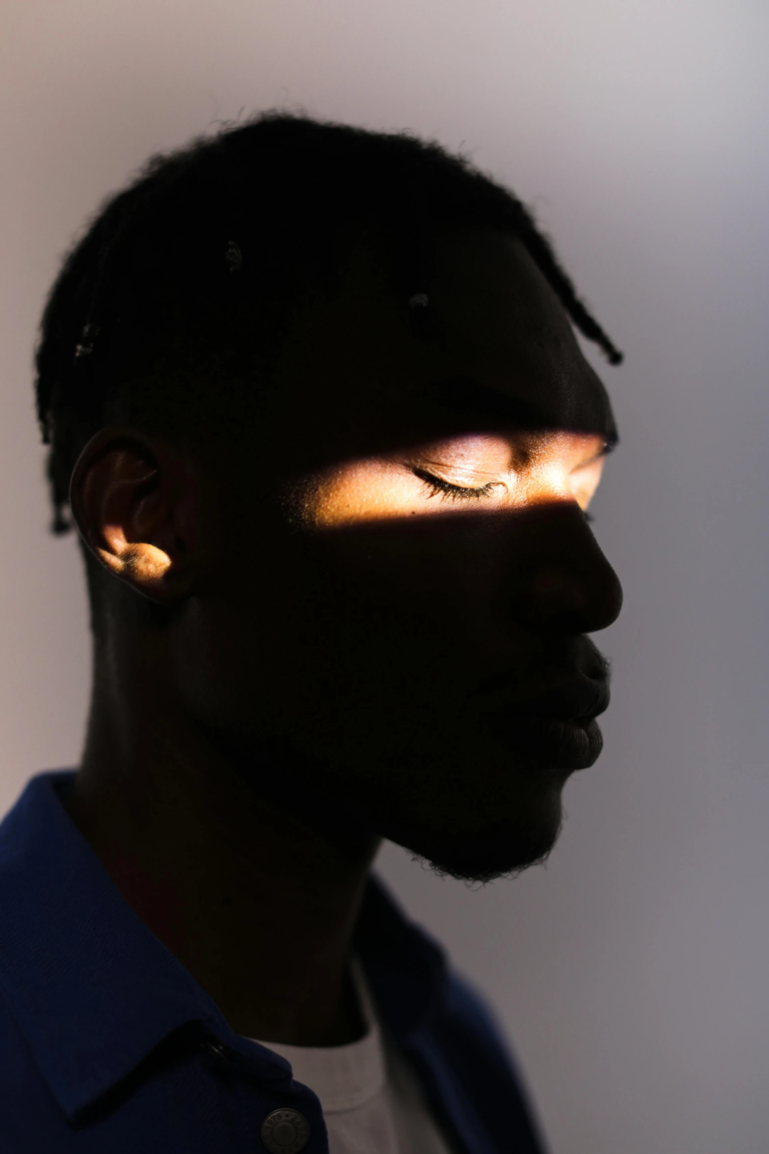 a close up of a person with a cell phone in their hand, an album cover, trending on pexels, light and space, man is with black skin, glowing light and shadows, headshot profile picture, portrait of tall