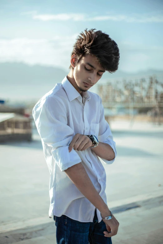 a young man wearing a white shirt and blue jeans, by Ismail Acar, pexels contest winner, profile pic, teen boy, wears a watch, neutral pose