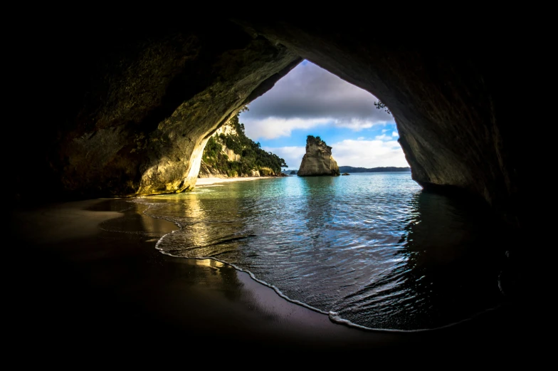 a view of the ocean from inside a cave, unsplash contest winner, renaissance, abel tasman, chrome cathedrals, slide show, on black background