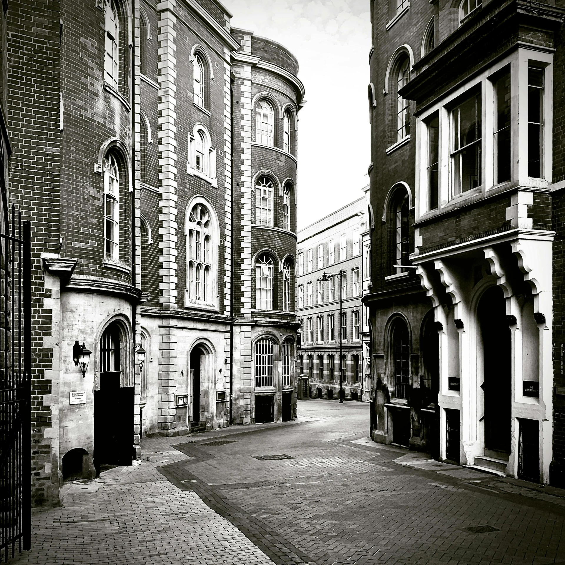 a black and white photo of a city street, a black and white photo, baroque, victorian london, courtyard, hasselblad photograph, neoclassical police station