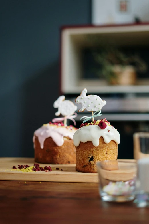 a couple of cakes sitting on top of a wooden table, by Sylvia Wishart, unsplash, easter, multiple stories, indoor shot, fully decorated