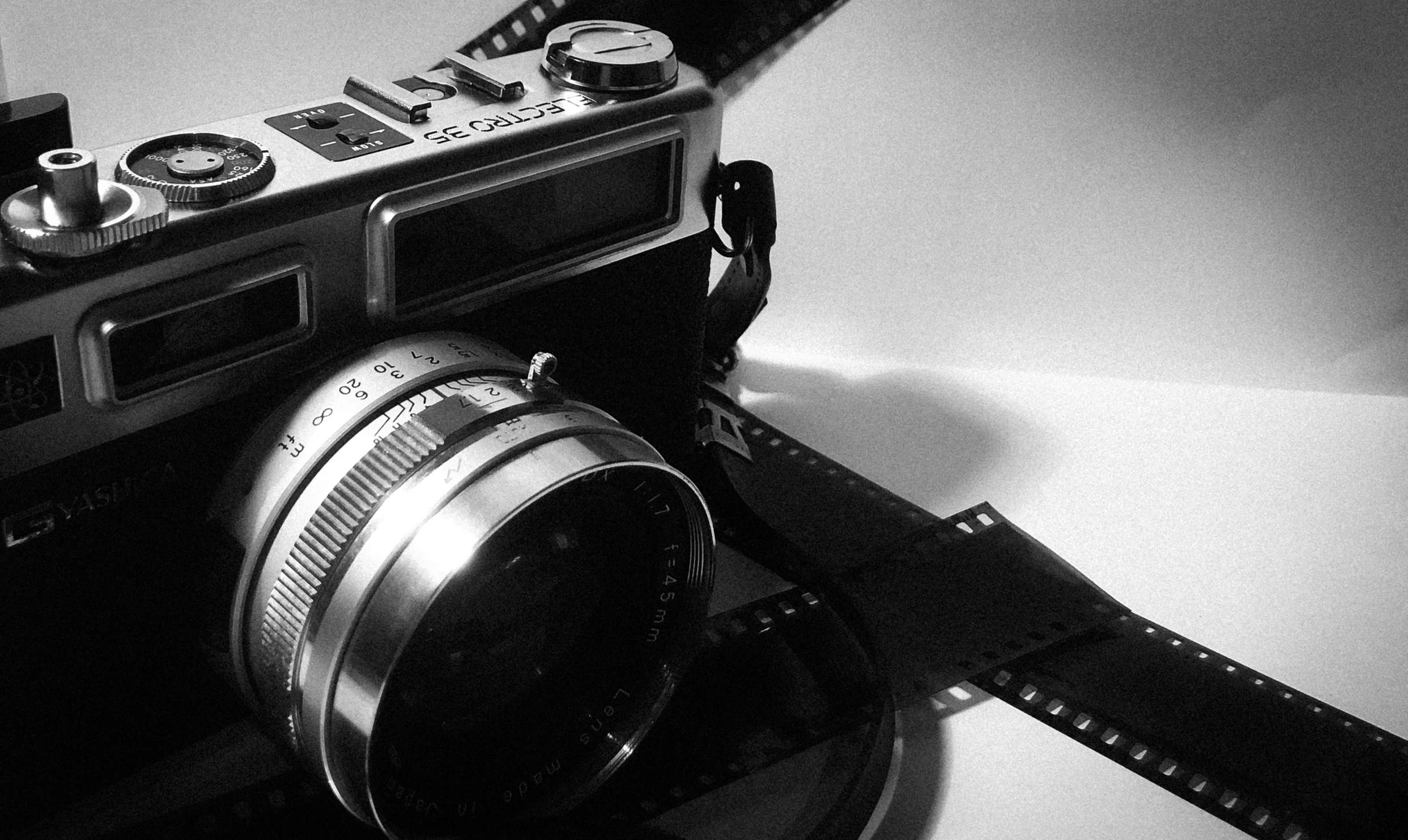 a black and white photo of a camera, a black and white photo, pixabay, art photography, \!cinestill 50d! film photo, silver gelatin print, cute photograph, color film photography