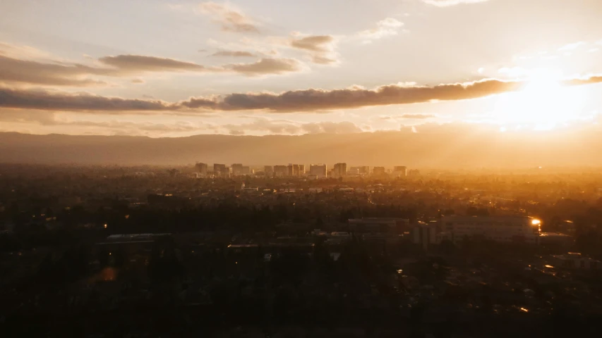 a view of the sun setting over a city, pexels contest winner, central california, ultrawide cinematic, unsplash photo contest winner, sun and shadow over a city