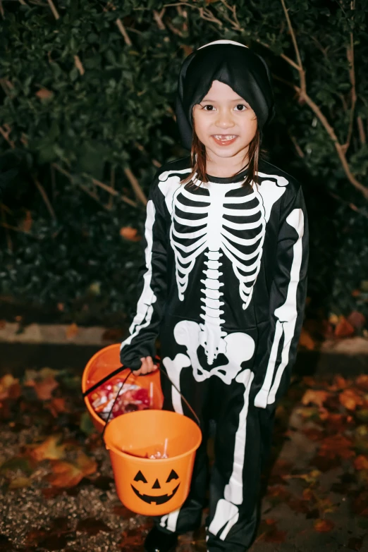 a little girl dressed up in a skeleton costume, candy treatments, nighttime!, 💣 💥, poop