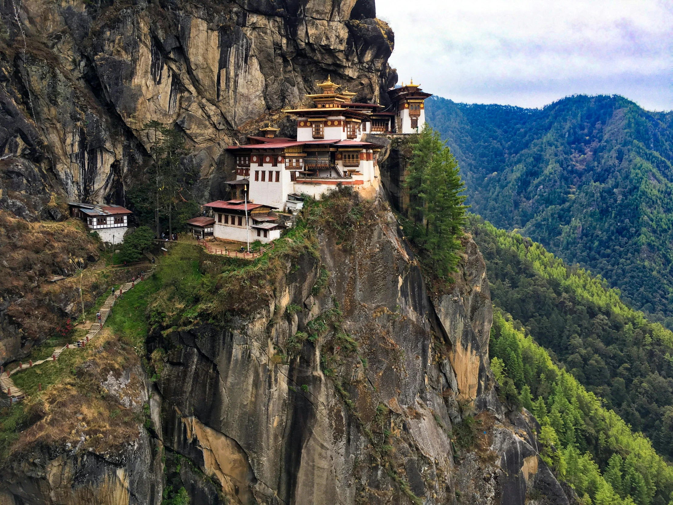 the tiger's nest monastery on the edge of a cliff, inspired by Steve McCurry, pexels contest winner, hurufiyya, 1970s photo