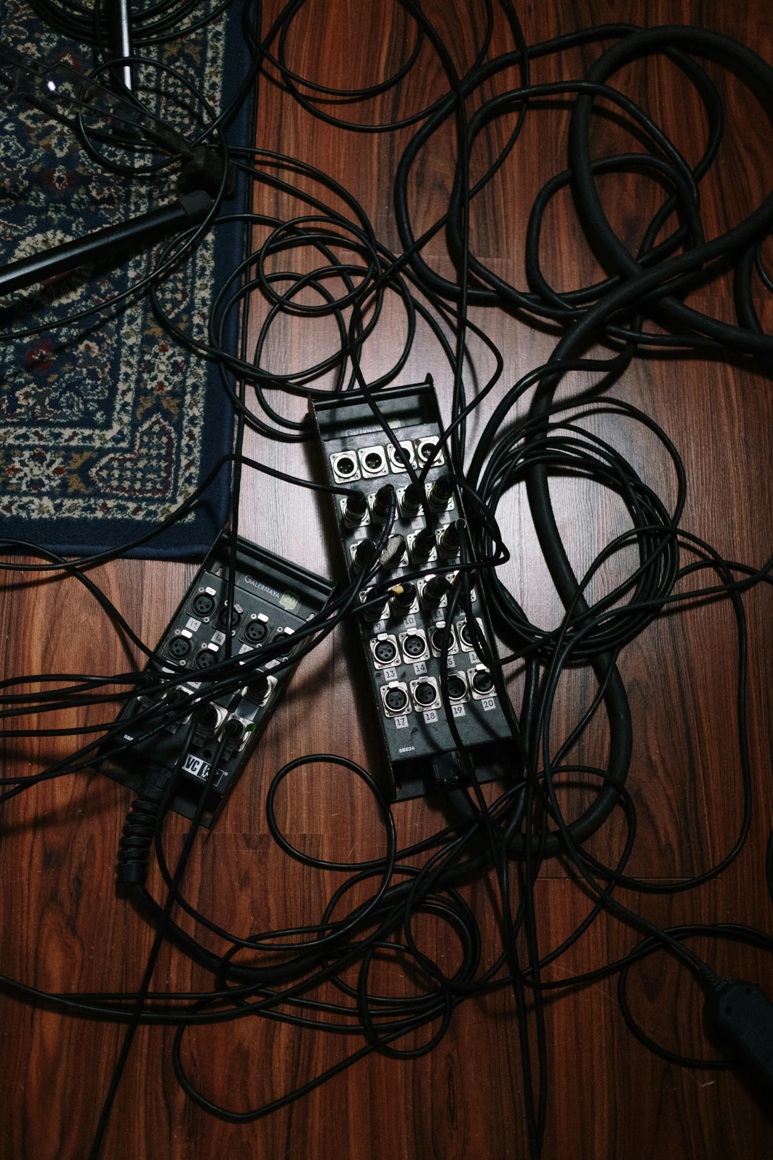 a pile of electronics sitting on top of a wooden floor, an album cover, reddit, fluxus, piles of modular synth cables, carpet at the floor, worship, dark tone