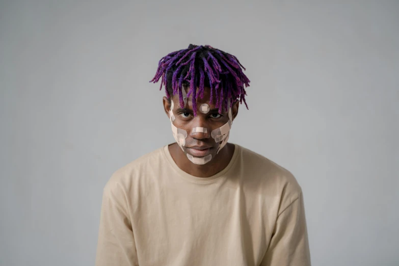 a man with purple hair and white face paint, trending on pexels, afrofuturism, lean man with light tan skin, xxxtentacion, messy hair, handsome hip hop young black man