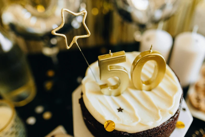 a close up of a cake on a table, by Julia Pishtar, trending on unsplash, figuration libre, 50 years old, golden number, -step 50, old hollywood themed