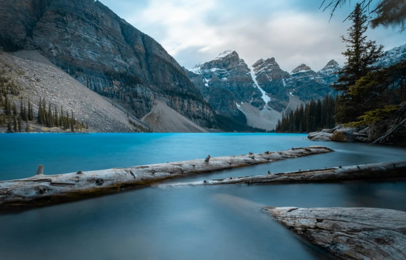 a large body of water surrounded by trees, by Matthias Weischer, pexels contest winner, hurufiyya, banff national park, blue glacier, rocky mountains, hd wallpaper