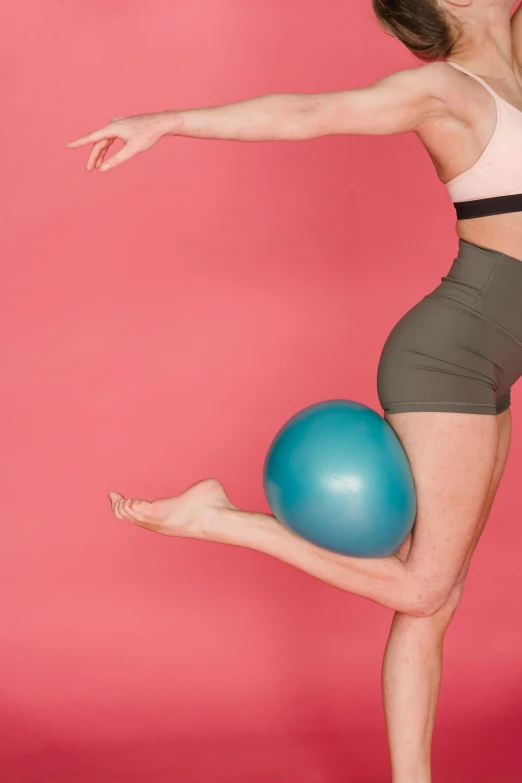 a woman doing a yoga pose with a blue ball, an album cover, by Rachel Reckitt, trending on pexels, arabesque, thigh gap, balloon, pink and teal, 15081959 21121991 01012000 4k