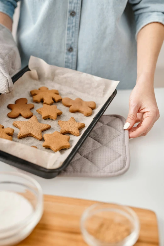 a close up of a person holding a tray of cookies, cooking, case, grey, thumbnail