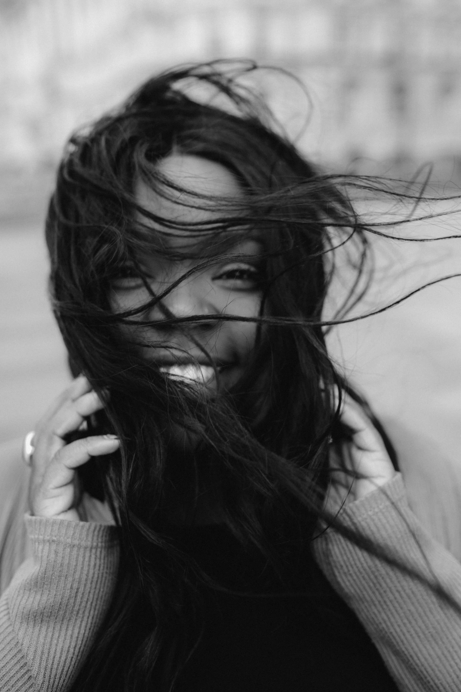 a black and white photo of a woman with long hair, by Felix-Kelly, sza, having fun. vibrant, with a covered face, wind - swept