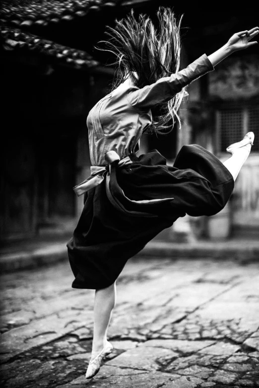 a woman that is jumping in the air, a black and white photo, inspired by Liao Chi-chun, featured on cgsociety, fisting monk, 15081959 21121991 01012000 4k, tai costume, doing a kick