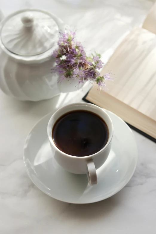 a cup of coffee and a book on a table, botanicals, up close, superior, multiple stories