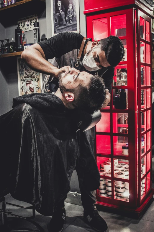 a man getting his hair cut in a barber shop, by Julia Pishtar, pexels contest winner, horror themed, square masculine jaw, slicked black hair, full colour