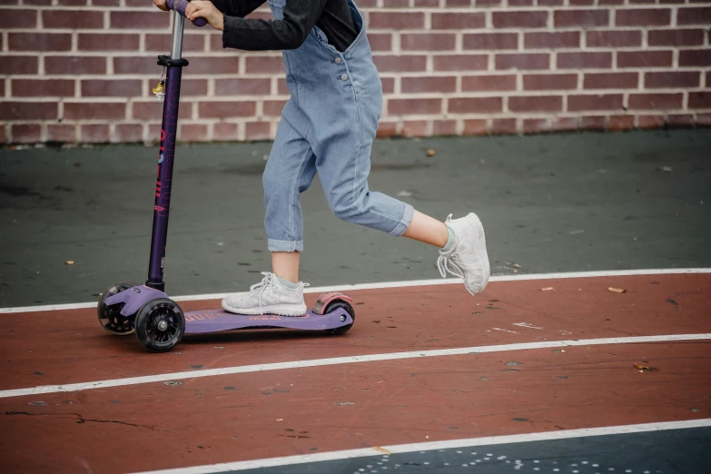 a little girl riding on top of a purple scooter, pexels contest winner, realism, sneakers, private school, textured base ; product photos, playground