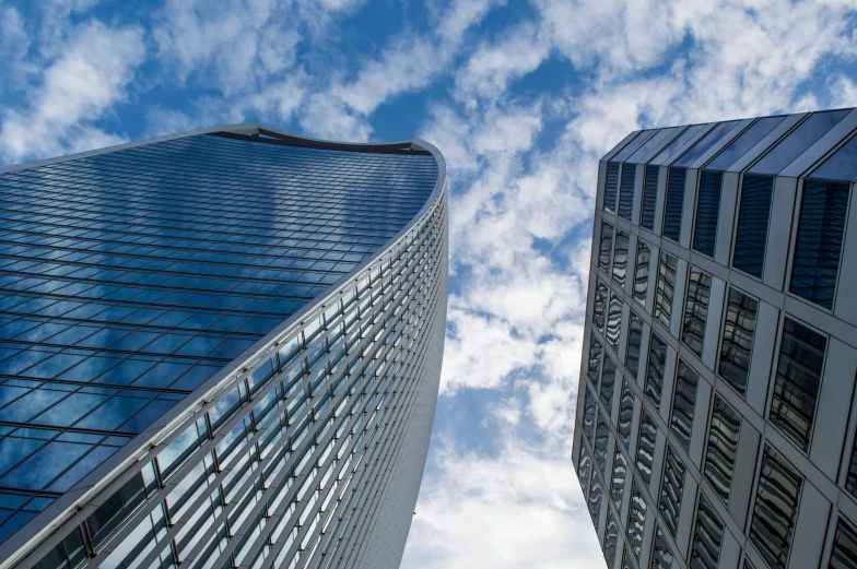 a couple of tall buildings next to each other, inspired by Zaha Hadid, pexels contest winner, blue sky above, norman foster, thumbnail, 1 5 0 4