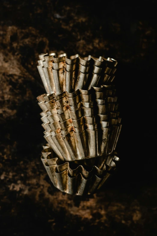 a bunch of bamboo sticks stacked on top of each other, an abstract sculpture, unsplash, renaissance, high detailed thin stalagmites, cupcake, silver, large shell