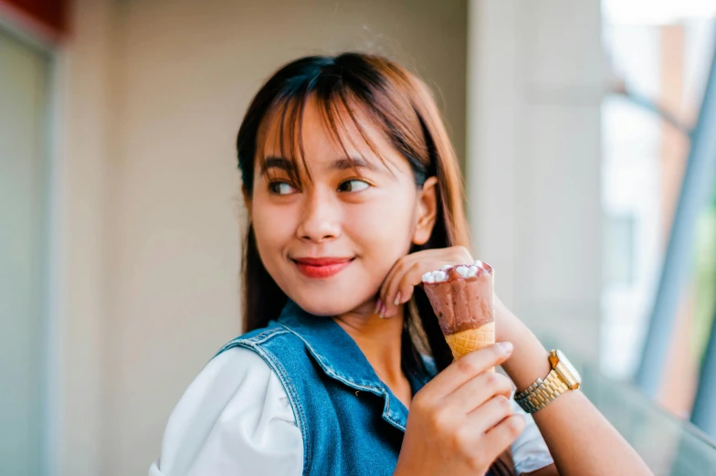a woman holding an ice cream cone in her hand, inspired by Kim Jeong-hui, pexels contest winner, portrait of modern darna, brown, pastelle, casual